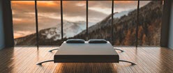 modern double bed overlooking snowcapped mountains through window